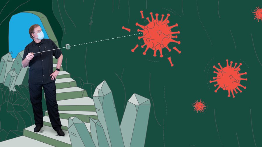Chris Barty, Ph.d. pointing a laser at a cell